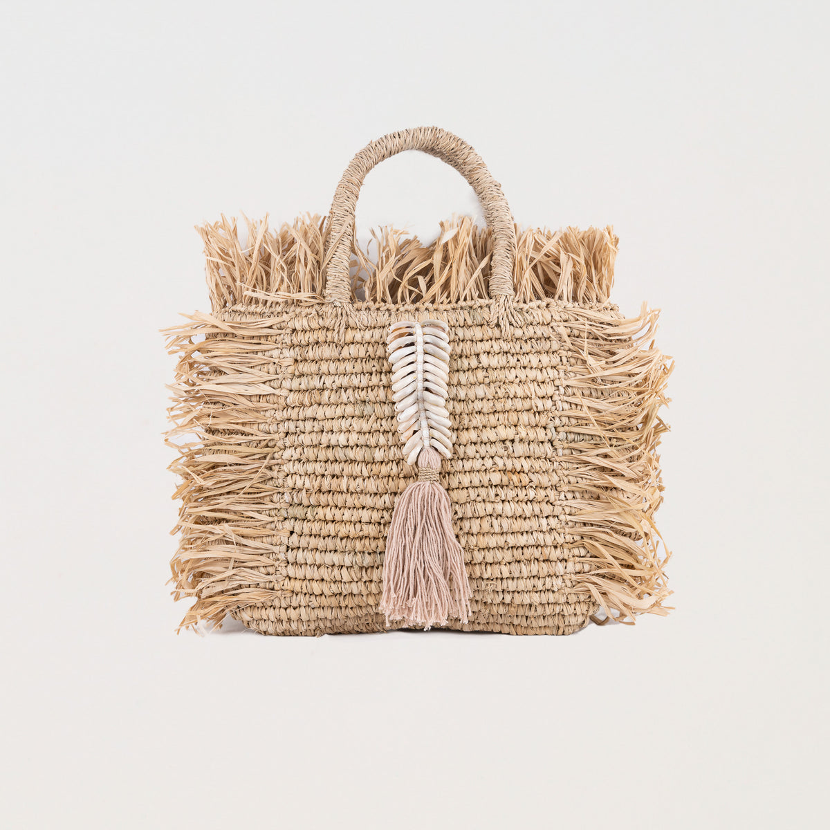Natural square raffia bag with fringe and shell decorations. Handheld and fully lined with inside pocket. 