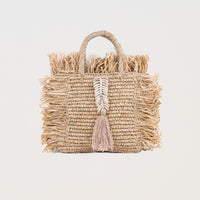 Natural square raffia bag with fringe and shell decorations. Handheld and fully lined with inside pocket. 