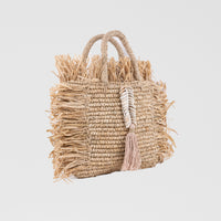 Natural square raffia bag with fringe and shell decorations. Handheld and fully lined with inside pocket. 