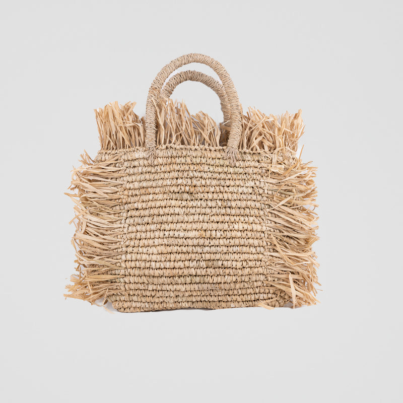 Natural square raffia bag with fringe and shell decorations. Handheld and fully lined with inside pocket. 