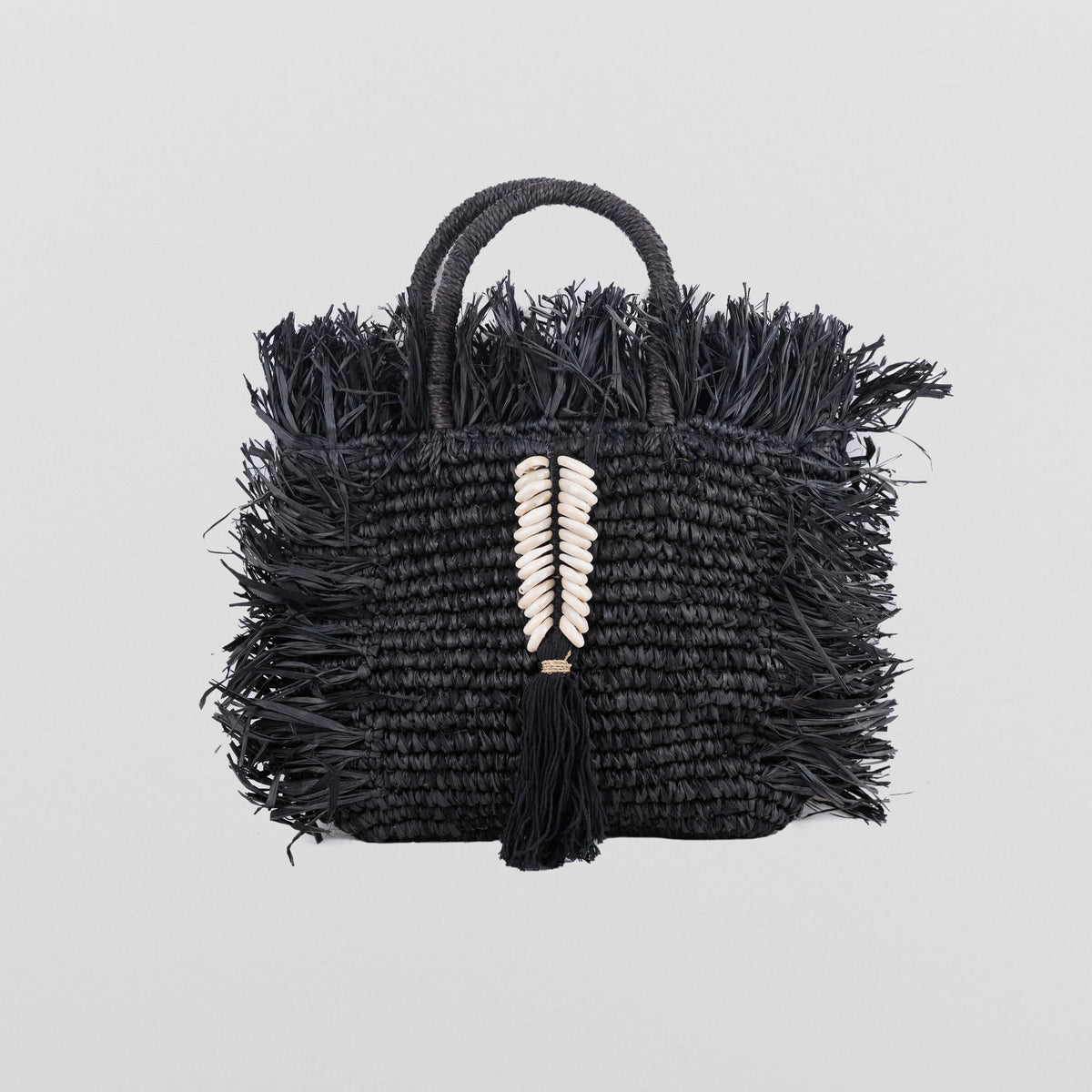 Black Square raffia bag with fringe and shell decorations. Handheld and fully lined with inside pocket. 