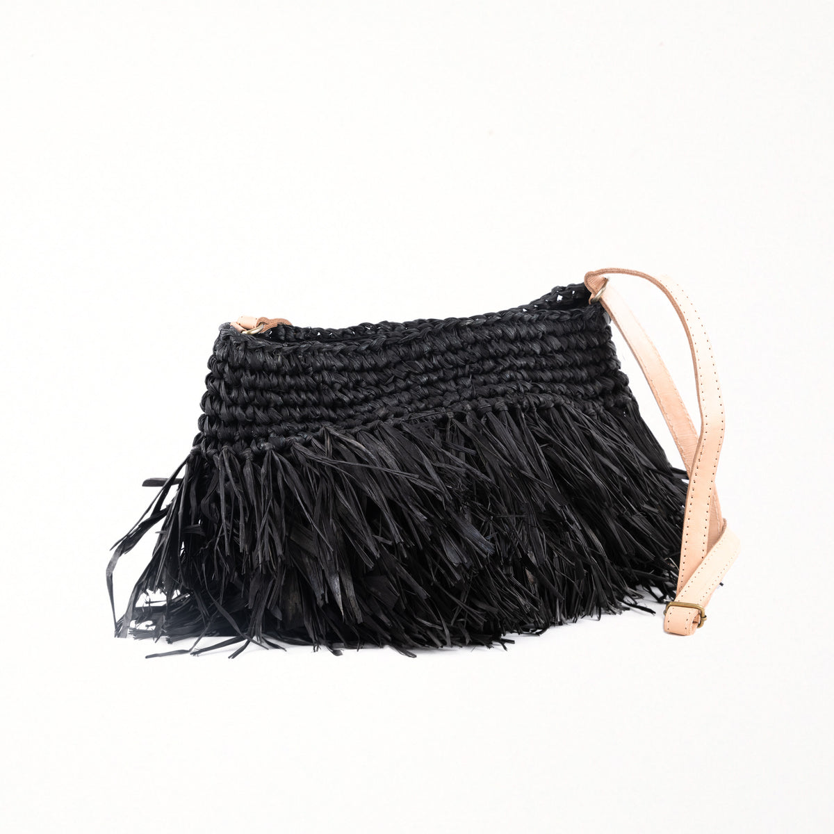 Small raffia black handbag with fringing detail. Fully lined with inside pocket, adjustable leather shoulder straps and magnetic clasp closing.