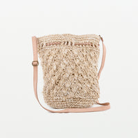 Raffia light handbag with textured pattern detail. Adjustable leather strap and leather pull-ties. Magnetic clasp closing. Fully lined with inside pocket.