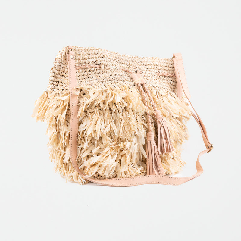 Large light raffia handbag with fringe detail and adjustable leather shoulder straps. Fully lined with inside pocket.