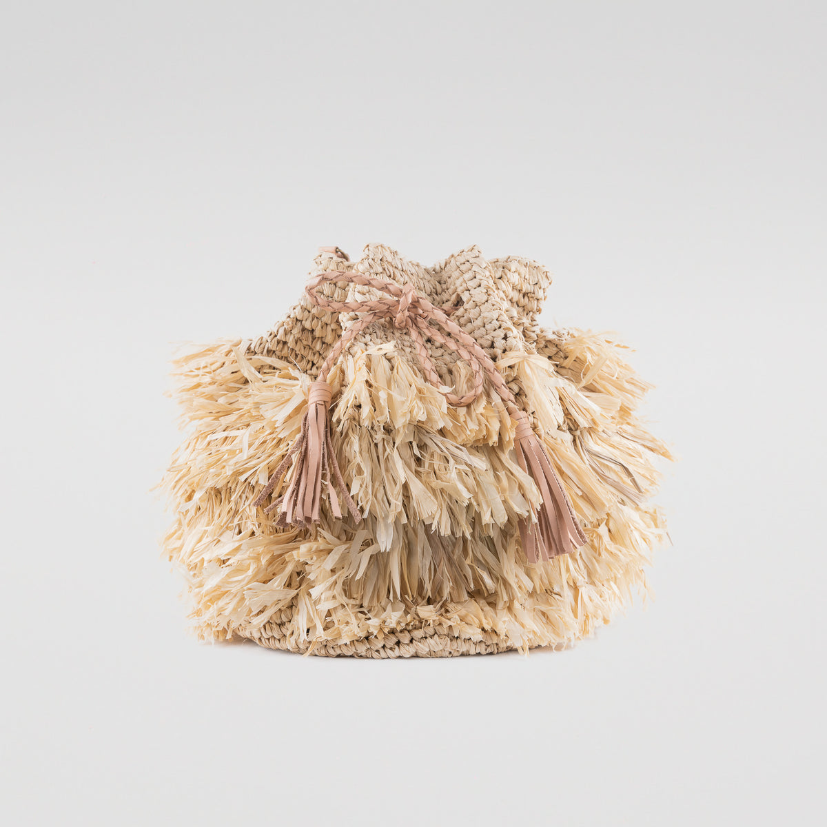 Large light raffia handbag with fringe detail and adjustable leather shoulder straps. Fully lined with inside pocket.