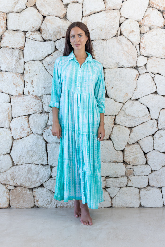 Womens button up long length tie dye dress in aqua blue featuring a tiered silhouette, 3/4 length sleeves and pockets 