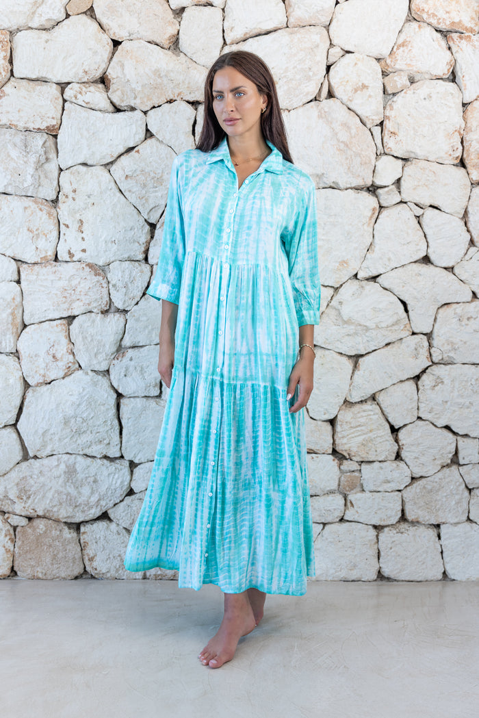 Womens button up long length tie dye dress in aqua blue featuring a tiered silhouette, 3/4 length sleeves and pockets 