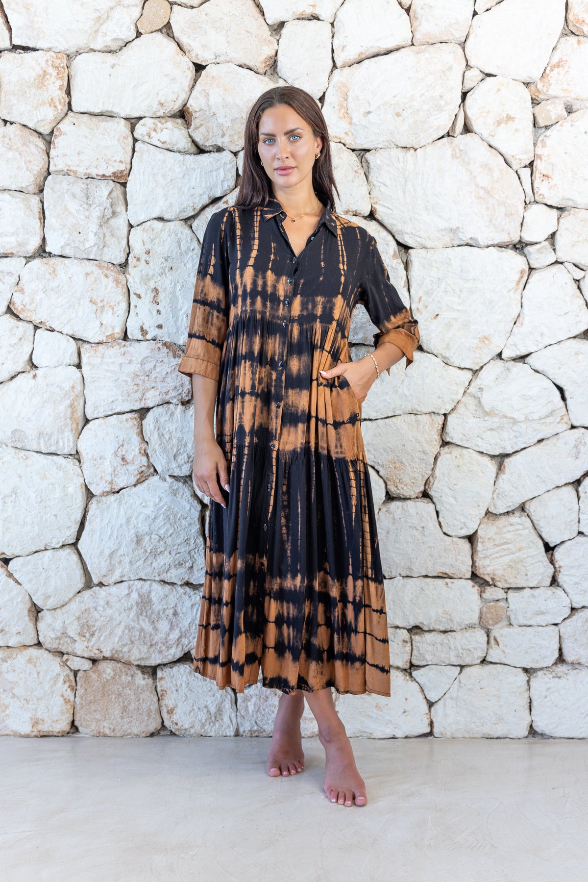 Womens button up long length tie dye dress in black and copper featuring a tiered silhouette, 3/4 length sleeves and pockets 