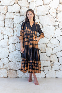 Womens button up long length tie dye dress in black and copper featuring a tiered silhouette, 3/4 length sleeves and pockets 