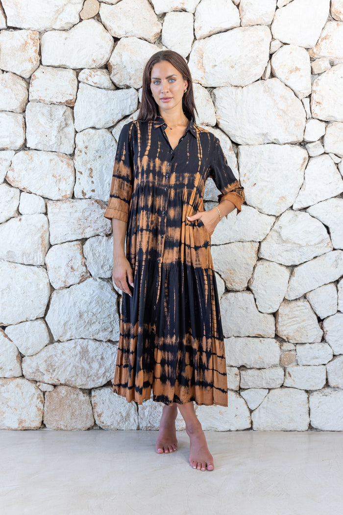 Womens button up long length tie dye dress in black and copper featuring a tiered silhouette, 3/4 length sleeves and pockets 