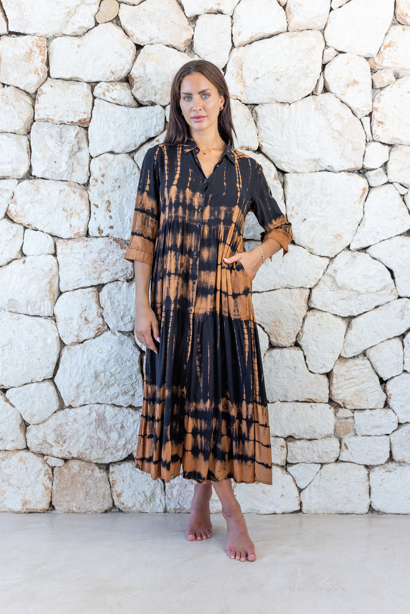 Womens button up long length tie dye dress in black and copper featuring a tiered silhouette, 3/4 length sleeves and pockets 