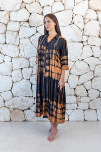Womens button up long length tie dye dress in black and copper featuring a tiered silhouette, 3/4 length sleeves and pockets 