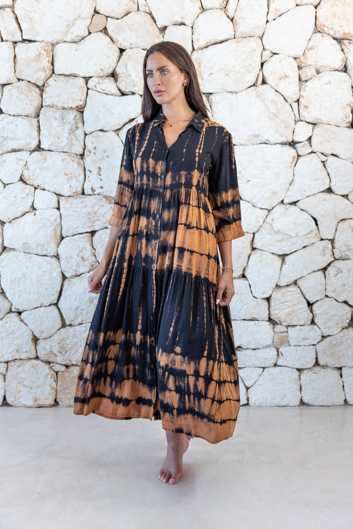 Womens button up long length tie dye dress in black and copper featuring a tiered silhouette, 3/4 length sleeves and pockets 