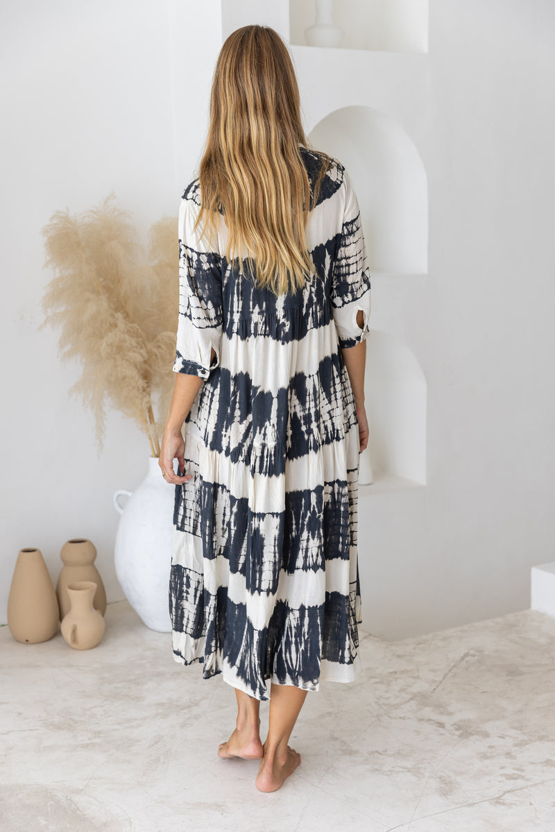 Womens button up mid length tie dye dress in black and cream featuring a tiered silhouette, 3/4 length sleeves and pockets 
