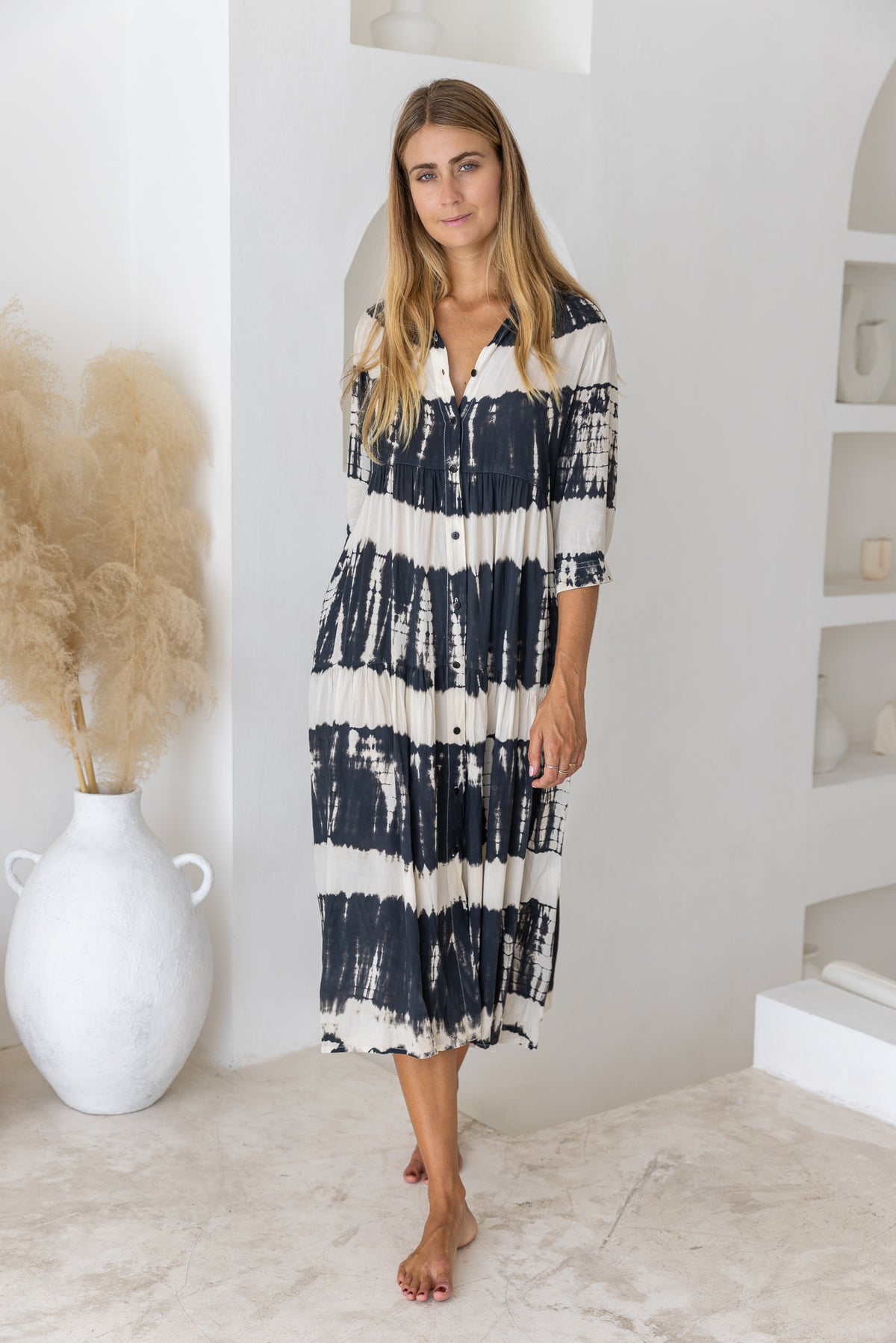 Womens button up mid length tie dye dress in black and cream featuring a tiered silhouette, 3/4 length sleeves and pockets 