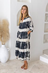 Womens button up mid length tie dye dress in black and cream featuring a tiered silhouette, 3/4 length sleeves and pockets 