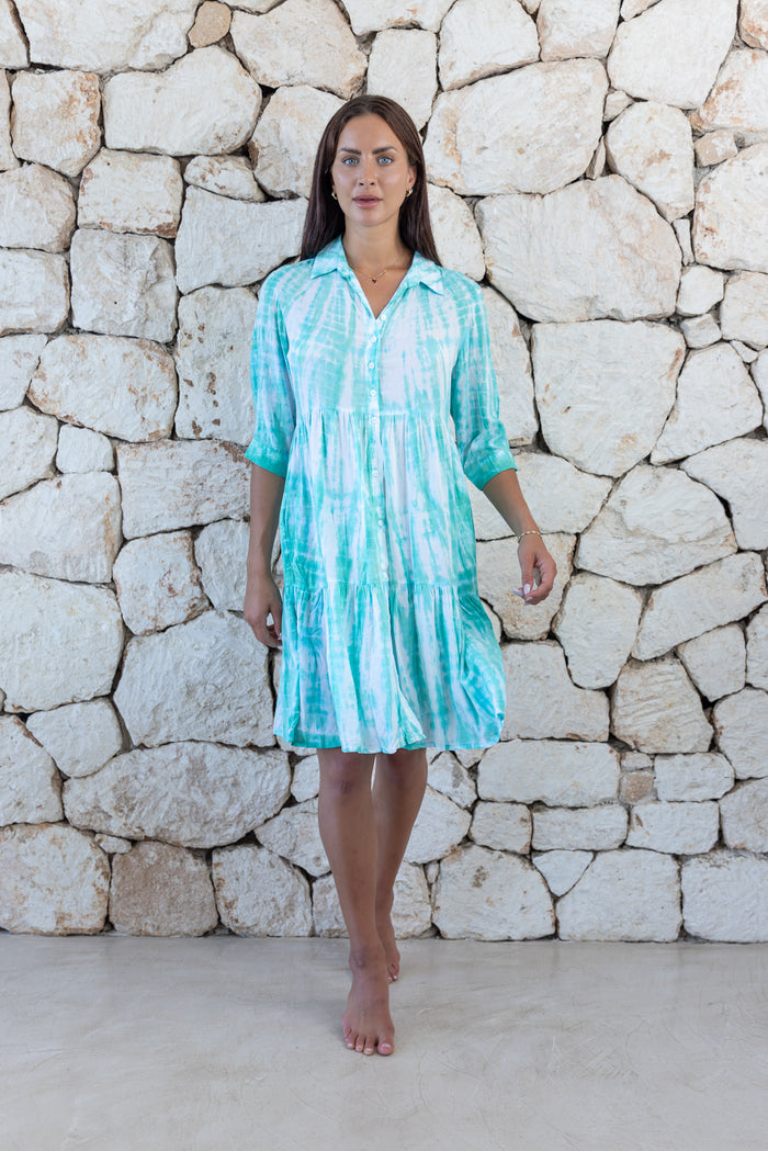 Womens button up short length tie dye dress in aqua blue featuring a tiered silhouette, 3/4 length sleeves and pockets 
