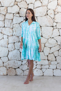 Womens button up short length tie dye dress in aqua blue featuring a tiered silhouette, 3/4 length sleeves and pockets 