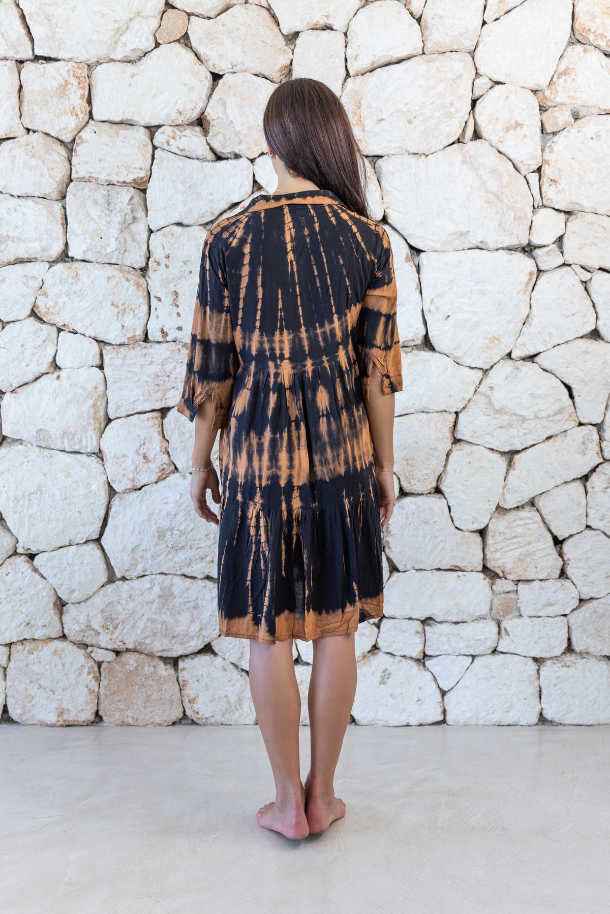 Womens button up short length tie dye dress in black and copper featuring a tiered silhouette, 3/4 length sleeves and pockets 