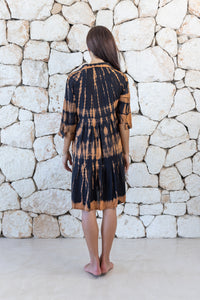 Womens button up short length tie dye dress in black and copper featuring a tiered silhouette, 3/4 length sleeves and pockets 