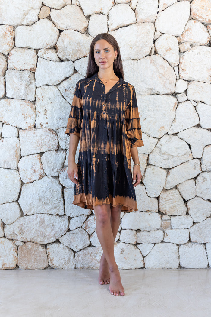 Womens button up short length tie dye dress in black and copper featuring a tiered silhouette, 3/4 length sleeves and pockets 