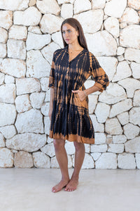 Womens button up short length tie dye dress in black and copper featuring a tiered silhouette, 3/4 length sleeves and pockets 