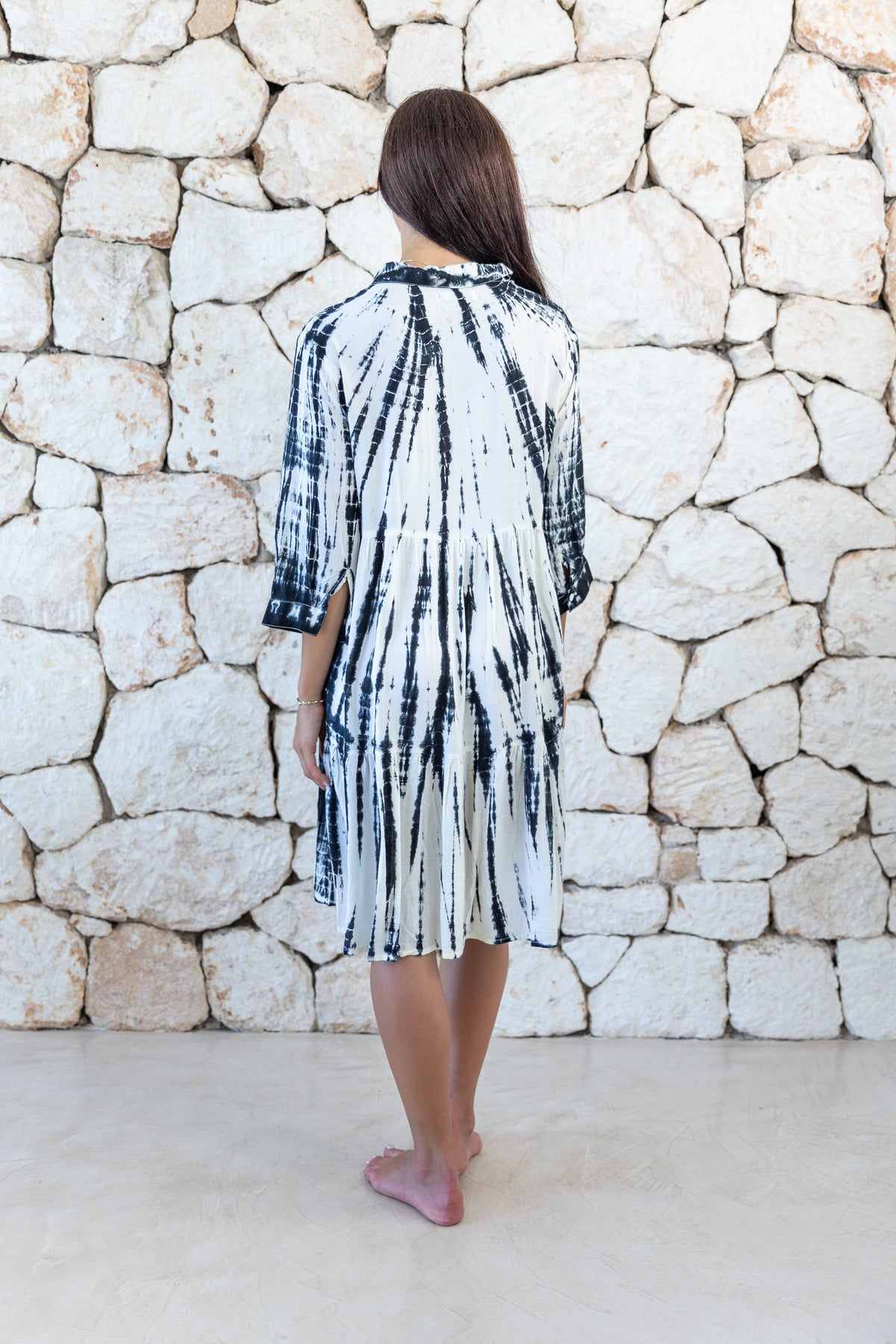 Womens button up short length tie dye dress in cream and black featuring a tiered silhouette, 3/4 length sleeves and pockets 