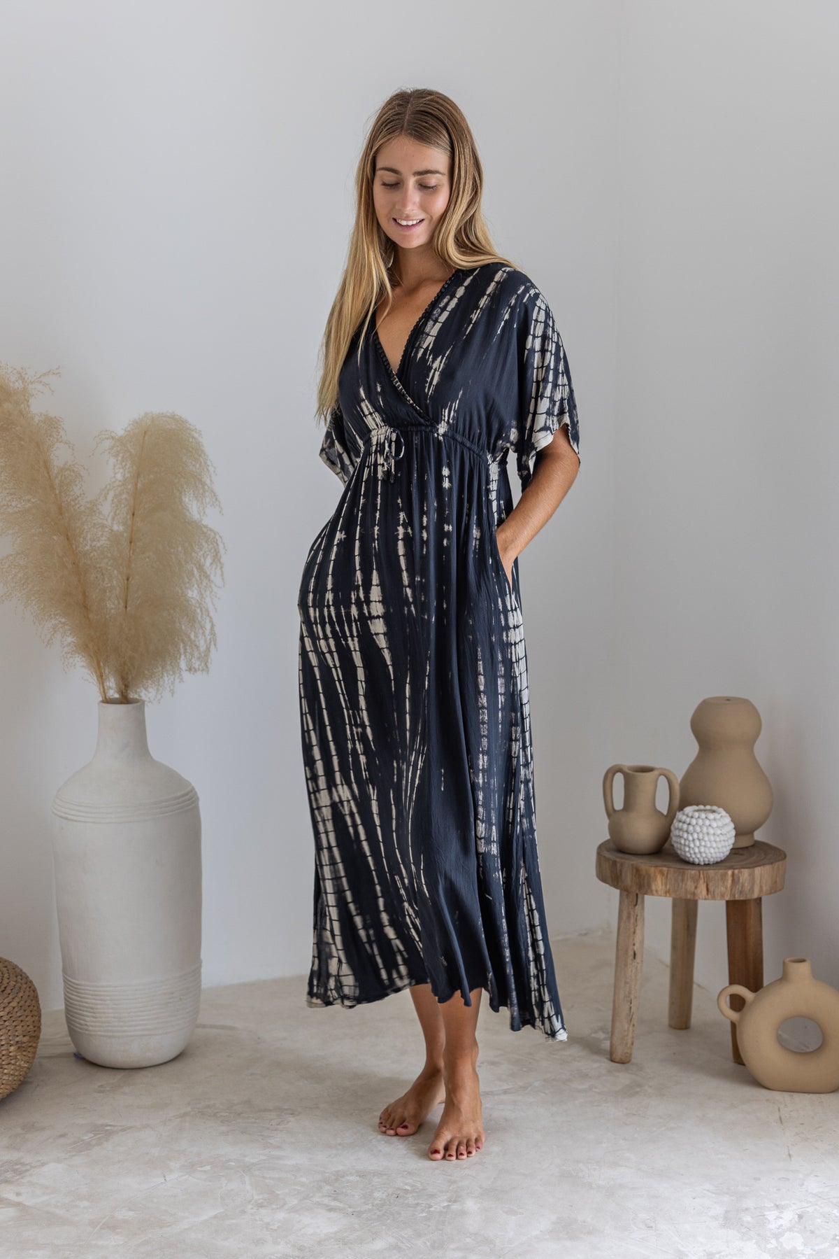 Womens mid length tie dye dress in black featuring a hand beaded neckline, kimono sleeves, elasticated waist and pockets