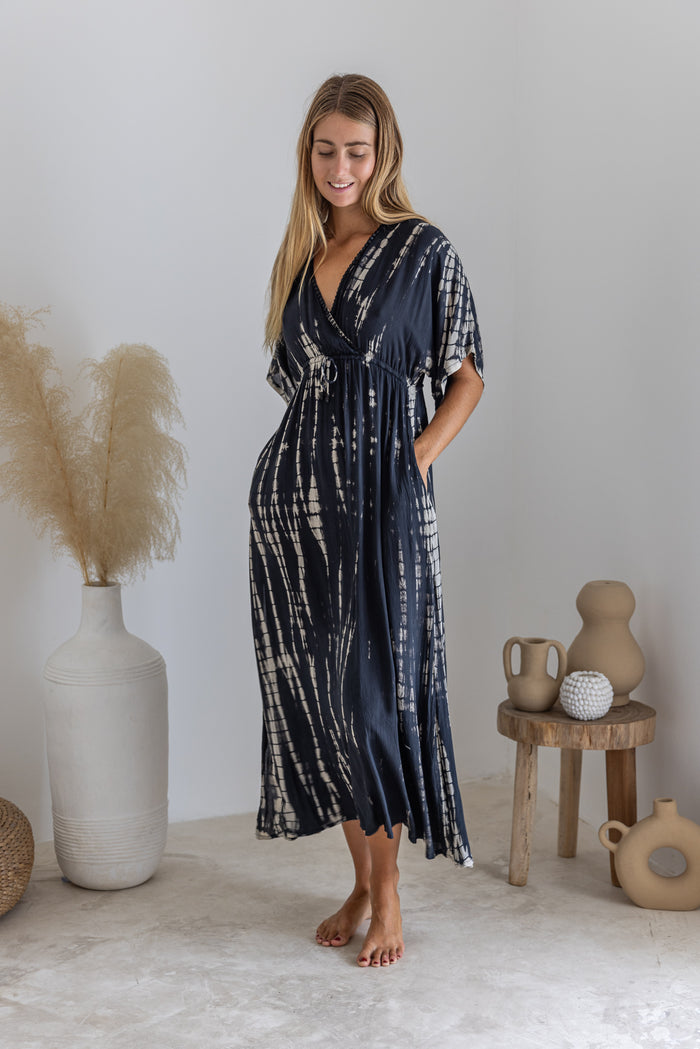 Womens mid length tie dye dress in black featuring a hand beaded neckline, kimono sleeves, elasticated waist and pockets