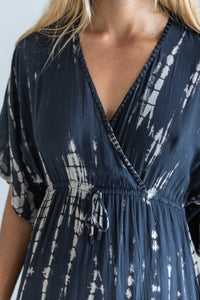 Womens mid length tie dye dress in black featuring a hand beaded neckline, kimono sleeves, elasticated waist and pockets
