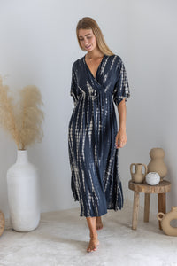 Womens mid length tie dye dress in black featuring a hand beaded neckline, kimono sleeves, elasticated waist and pockets