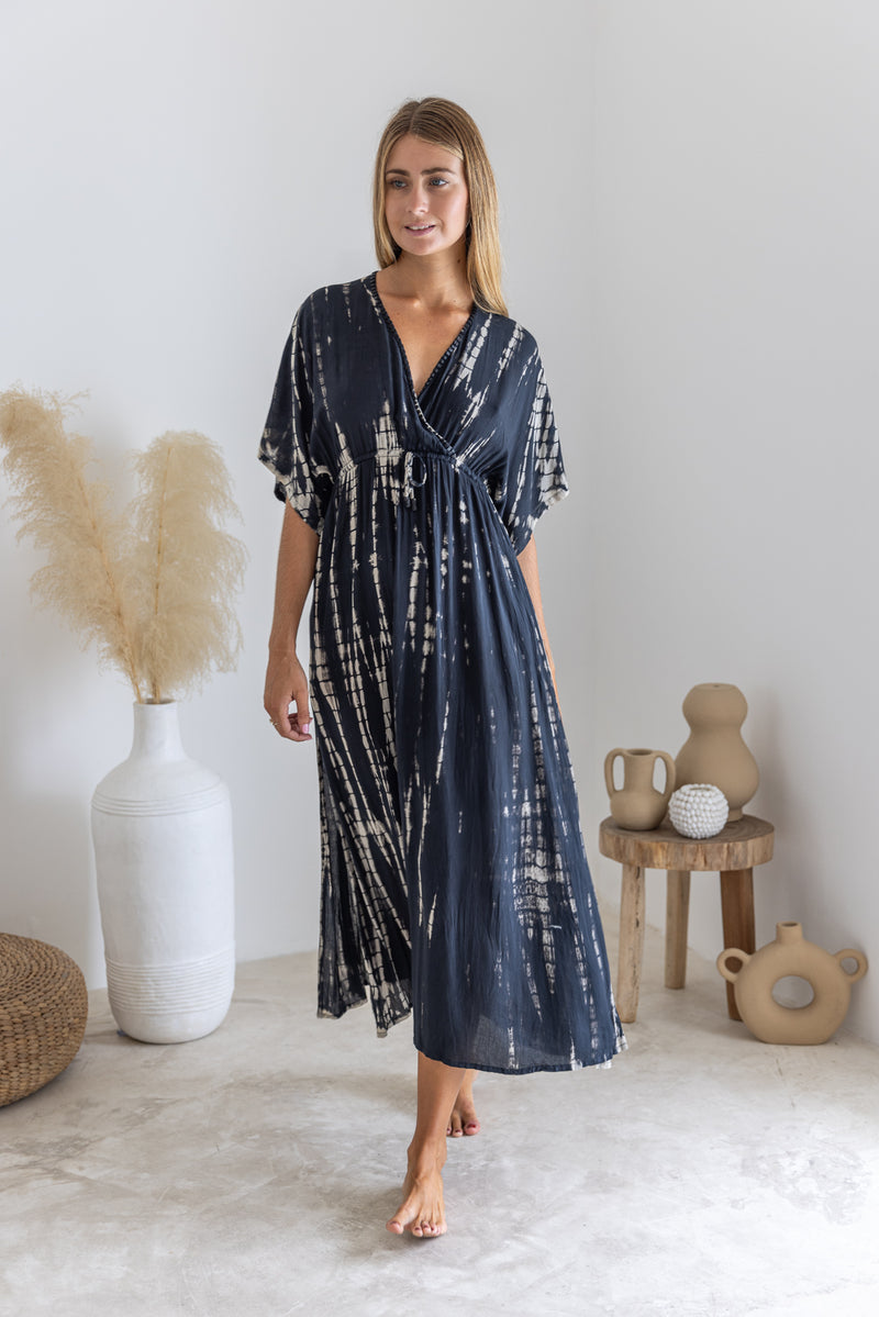 Womens mid length tie dye dress in black featuring a hand beaded neckline, kimono sleeves, elasticated waist and pockets