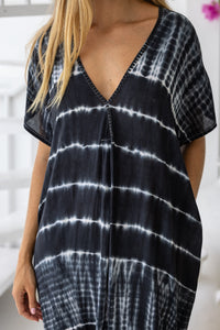 Womens mid length oversize tie dye kaftan in black featuring a hand beaded neckline, short sleeves and pockets