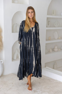 womens mid length tie dye tiered tunic dress in black featuring a v neckline, long sleeves and side pockets