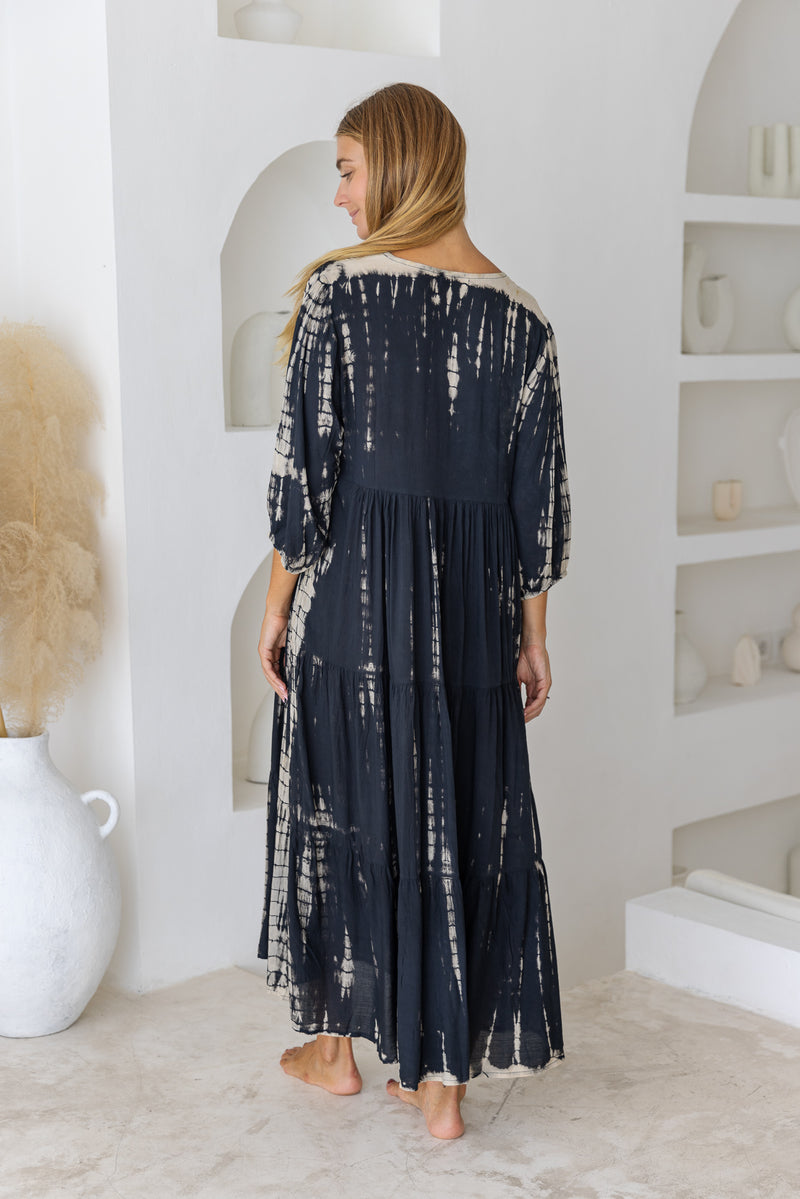 womens mid length tie dye tiered tunic dress in black featuring a v neckline, long sleeves and side pockets