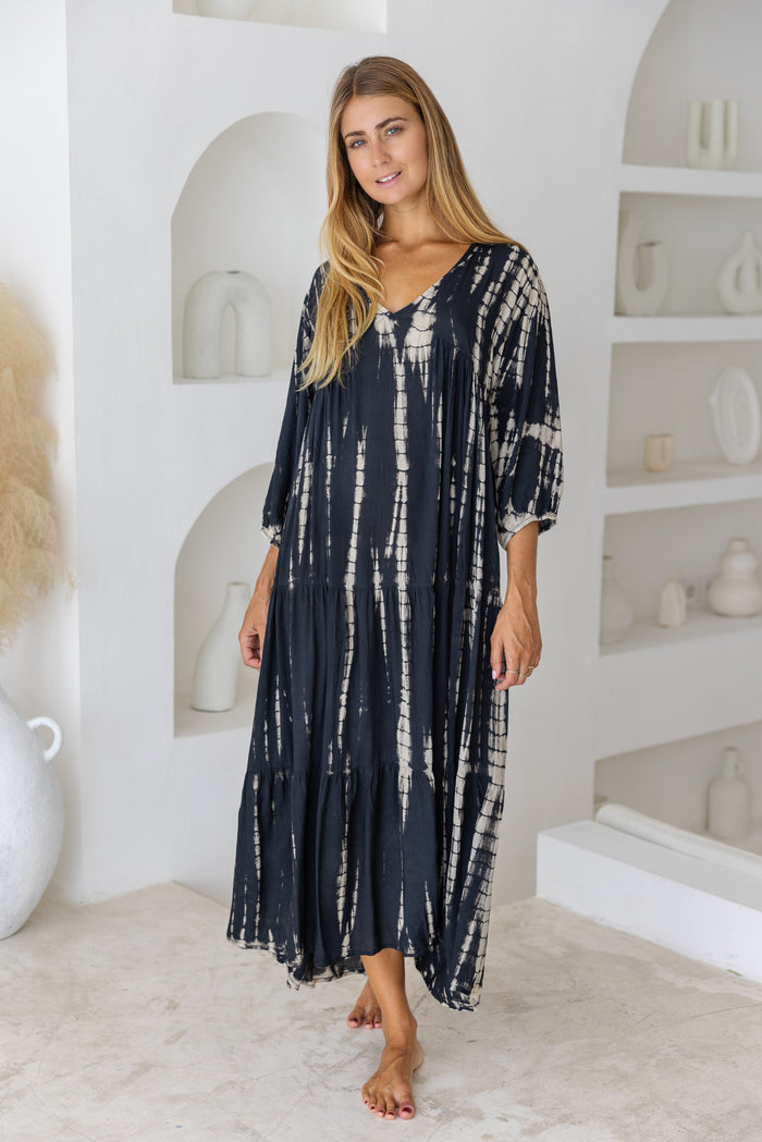 womens mid length tie dye tiered tunic dress in black featuring a v neckline, long sleeves and side pockets