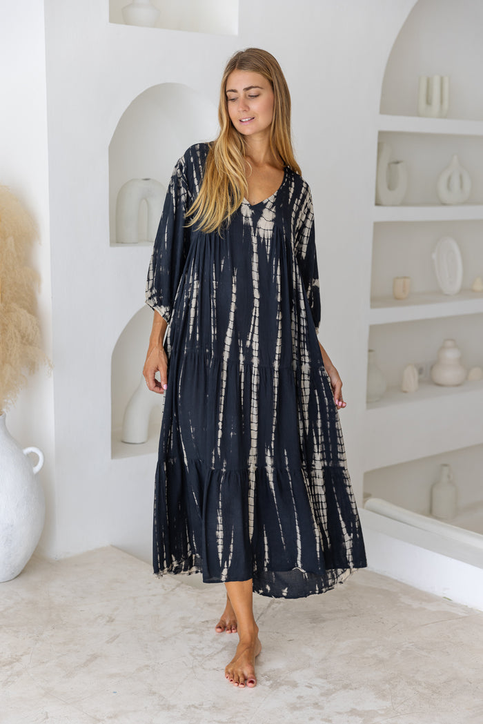 womens mid length tie dye tiered tunic dress in black featuring a v neckline, long sleeves and side pockets