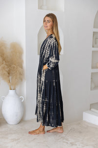 womens mid length tie dye tiered tunic dress in black featuring a v neckline, long sleeves and side pockets