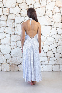 Womens stylish midi length halter neck dress in white polka dot featuring a deep V at the back with a pull tie detail under the bust