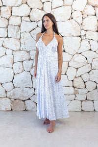 Womens stylish midi length halter neck dress in white polka dot featuring a deep V at the back with a pull tie detail under the bust