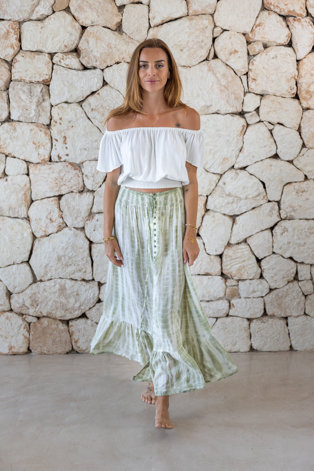Womens tie dye skirt in green featuring a smocked waist and button down front closing