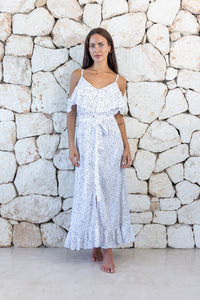 Womens elegant long length dress in white polka dot featuring cold shoulder sleeves, an elasticated waist, detachable belt detail and frill detailing 