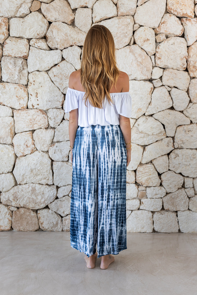 Stylish, super soft wide leg culotte style tie-dye trousers in navy and white featuring an elasticated waist, belt detail and pockets for a flattering and comfortable fit