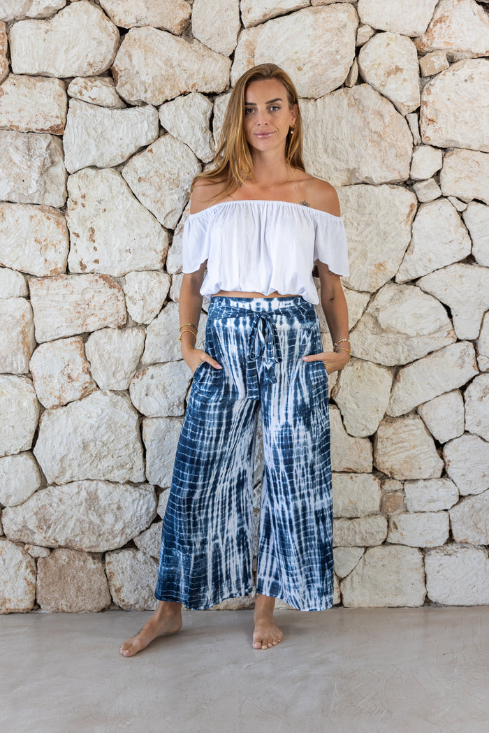 Stylish, super soft wide leg culotte style tie-dye trousers in navy and white featuring an elasticated waist, belt detail and pockets for a flattering and comfortable fit