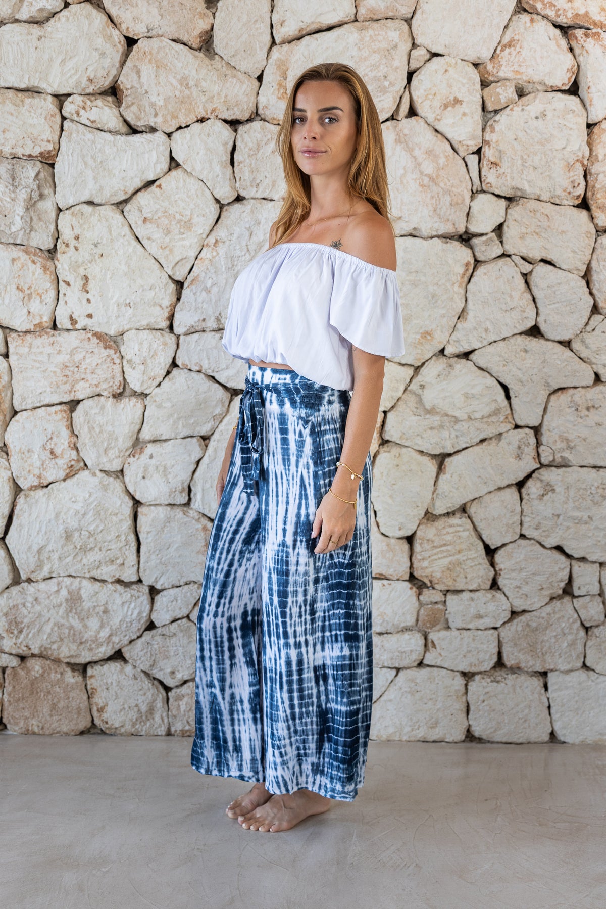 Stylish, super soft wide leg culotte style tie-dye trousers in navy and white featuring an elasticated waist, belt detail and pockets for a flattering and comfortable fit