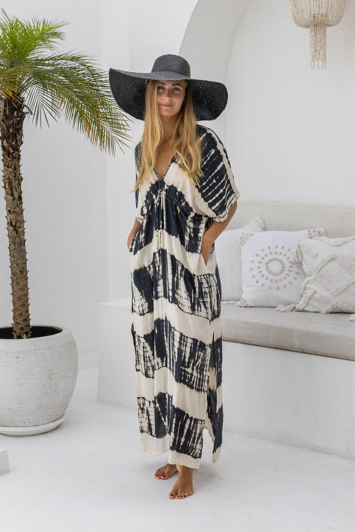 womens oversize maxi length tie dye kaftan in black and cream featuring a hand beaded neckline, pull tie detail and side pockets 

