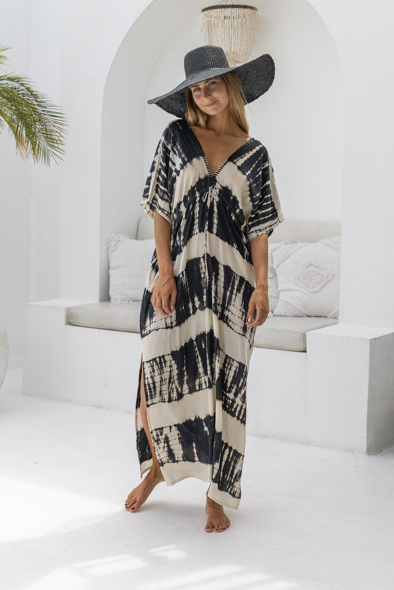 womens oversize maxi length tie dye kaftan in black and cream featuring a hand beaded neckline, pull tie detail and side pockets

