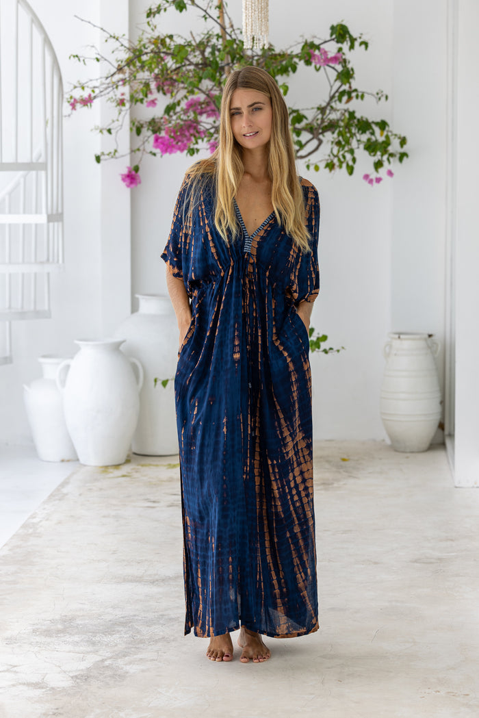 womens oversize maxi length tie dye kaftan in navy blue and brown and featuring a hand beaded neckline, pull tie detail and side pockets

