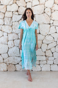 Womens full length tie dye summer dress in aqua blue featuring a hand beaded v neckline, pull ties under the bust, short sleeves and side splits