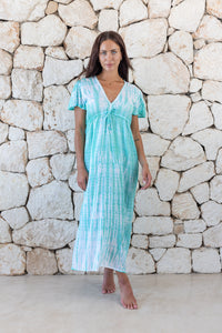 Womens full length tie dye summer dress in aqua blue featuring a hand beaded v neckline, pull ties under the bust, short sleeves and side splits